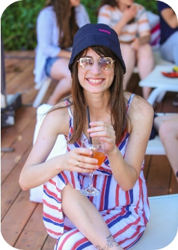 Woman outdoors at a function smiling to the camera